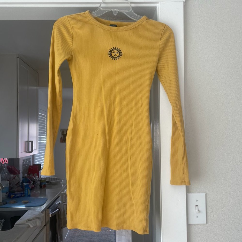 Yellow long sleeve form fitting dress with sun detail